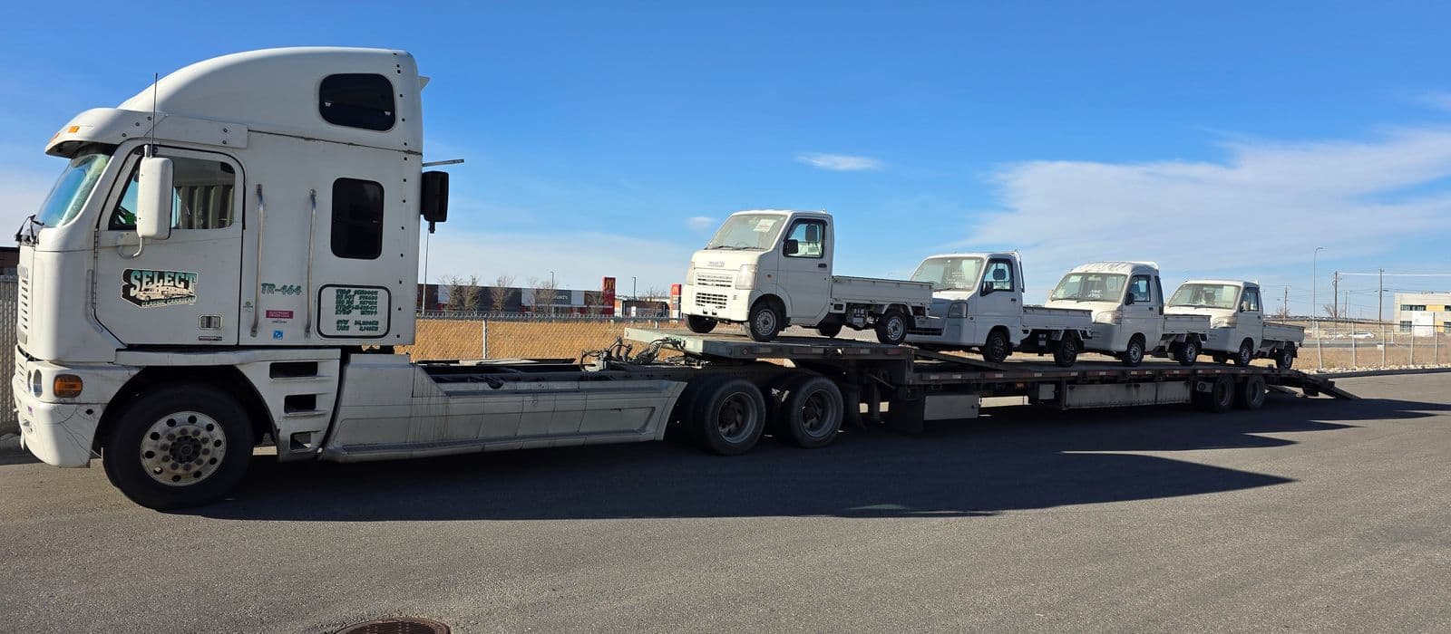 Kei trucks on transport trailer